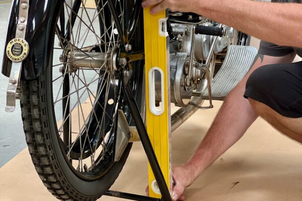 Packing master measuring placement of support boards during motorcycle packing
