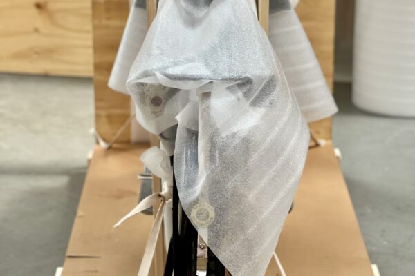 Motorcycle front view wrapped in thin foam and secured with cotton straps